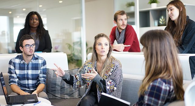 Work colleagues actively listen during a meeting