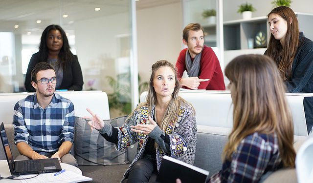 Work colleagues actively listen during a meeting